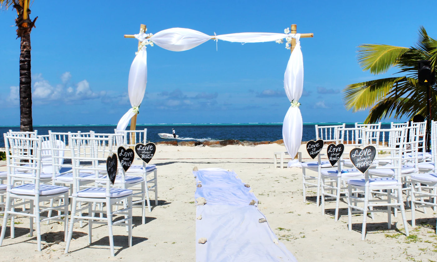 Beach wedding permit requirements in Florida — Bride in flowing gown walking along the shoreline at sunset