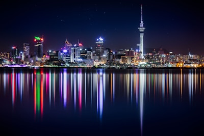 city buildings next to sea water during night