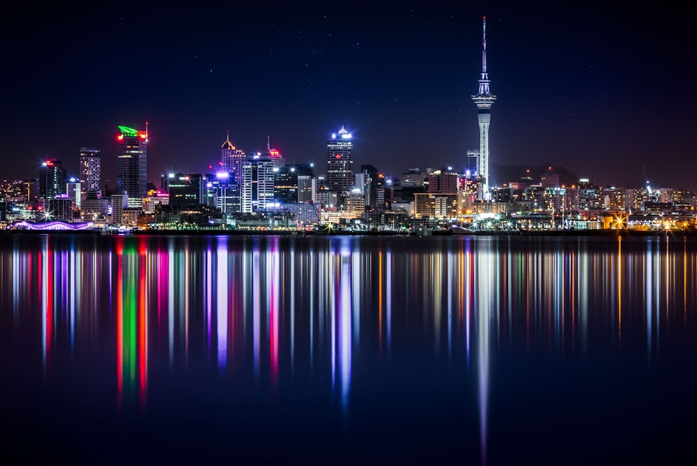 city buildings next to sea water during night