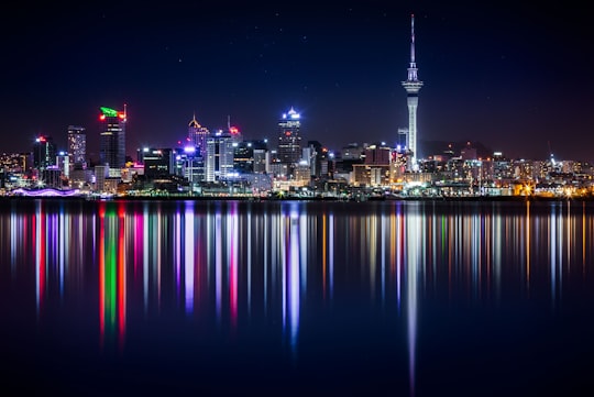 city buildings next to sea water during night in Spaghetti Junction New Zealand