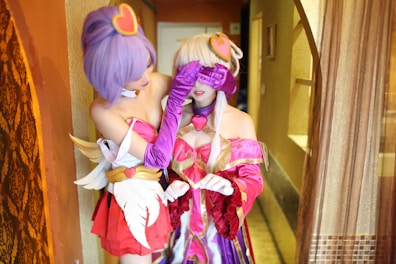A playful scene featuring two cosplayers in an intimate setting.
