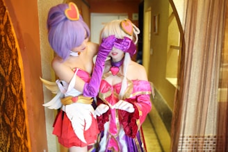 A playful scene featuring two cosplayers in an intimate setting.
