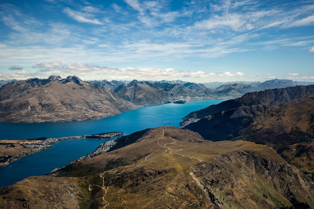 photo of mountains between body of water during daytime