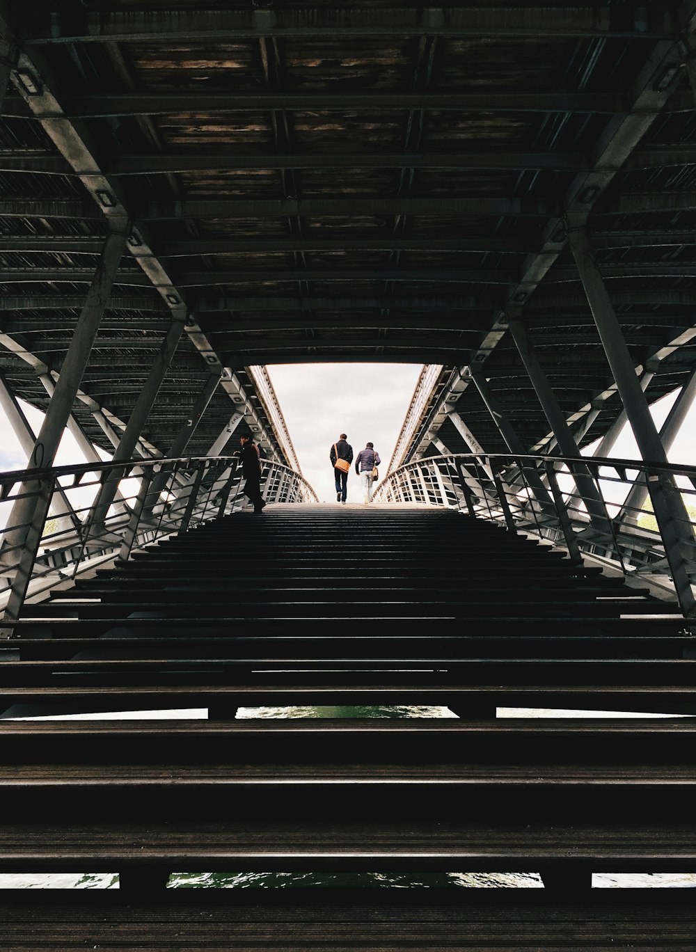 people walking up stairs low-angle photography