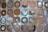 A decorative curtain composed of circular metallic discs interconnected with small rings, allowing light to filter through and casting muted reflections.