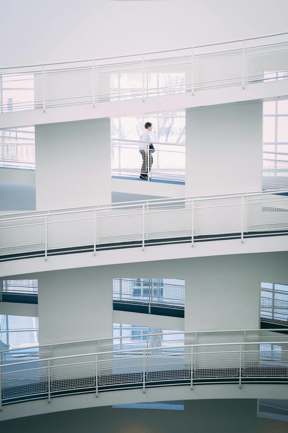 person walking on stairs inside building during daytime