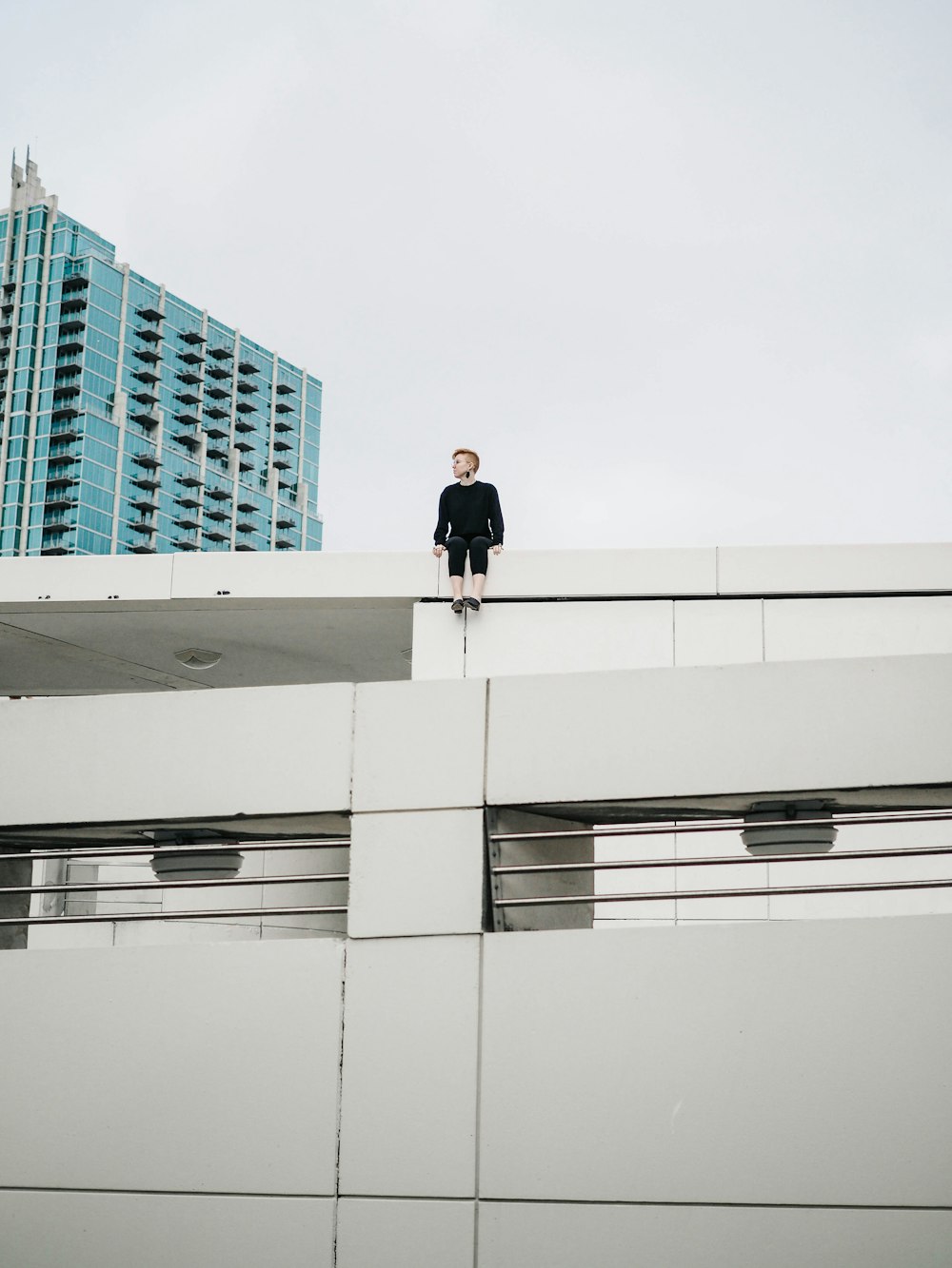 man sitting on top of roof deck