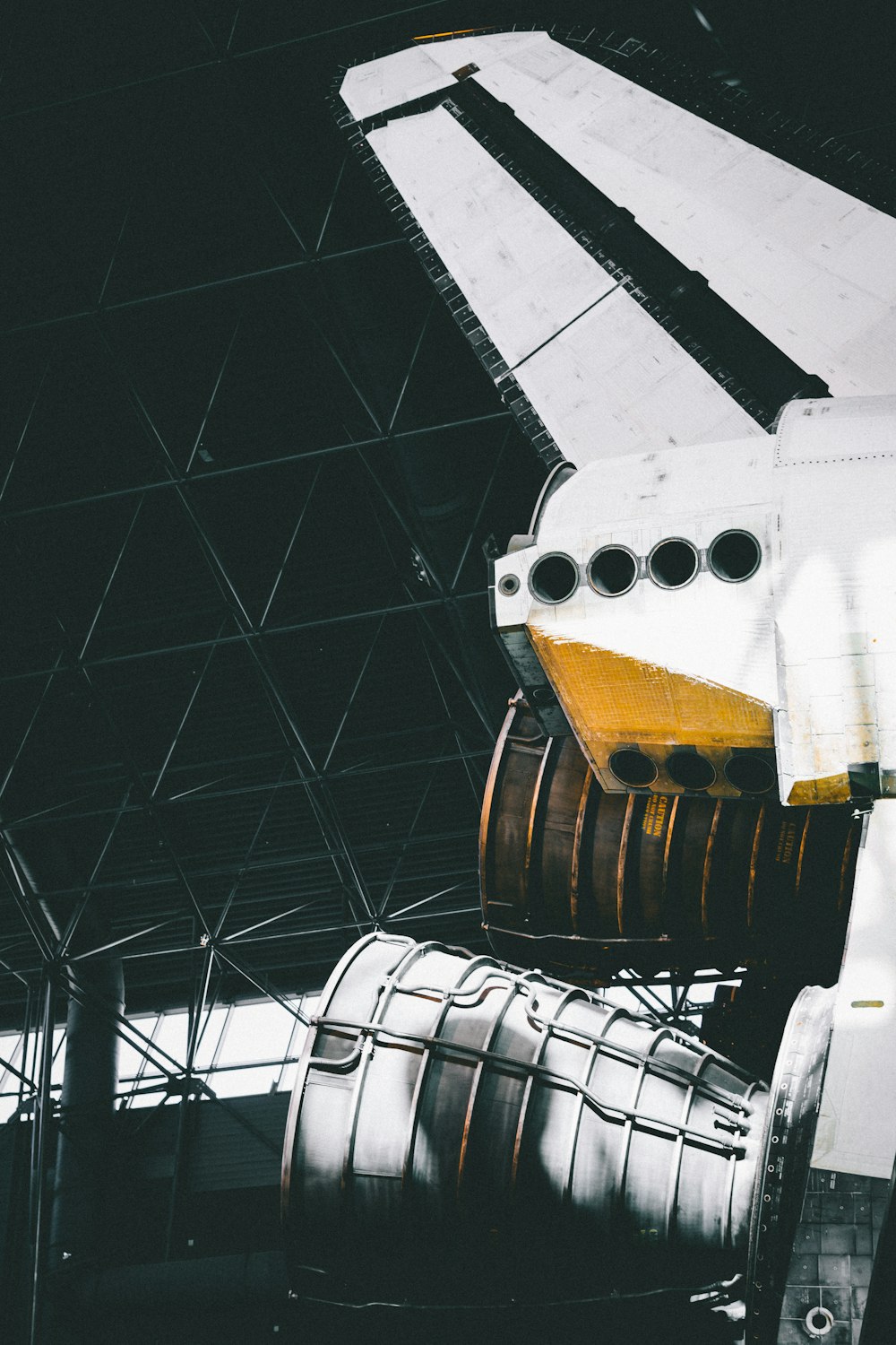 photo of white rocket ship inside warehouse