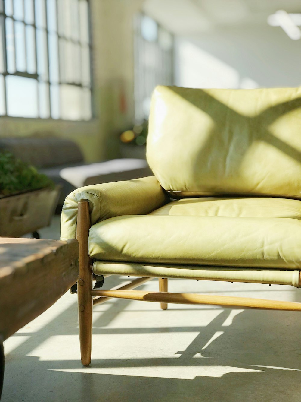 yellow leather sofa near window