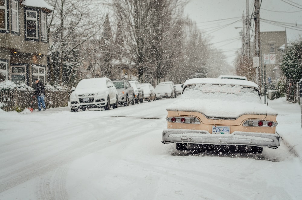 cars covered with snow outdoors