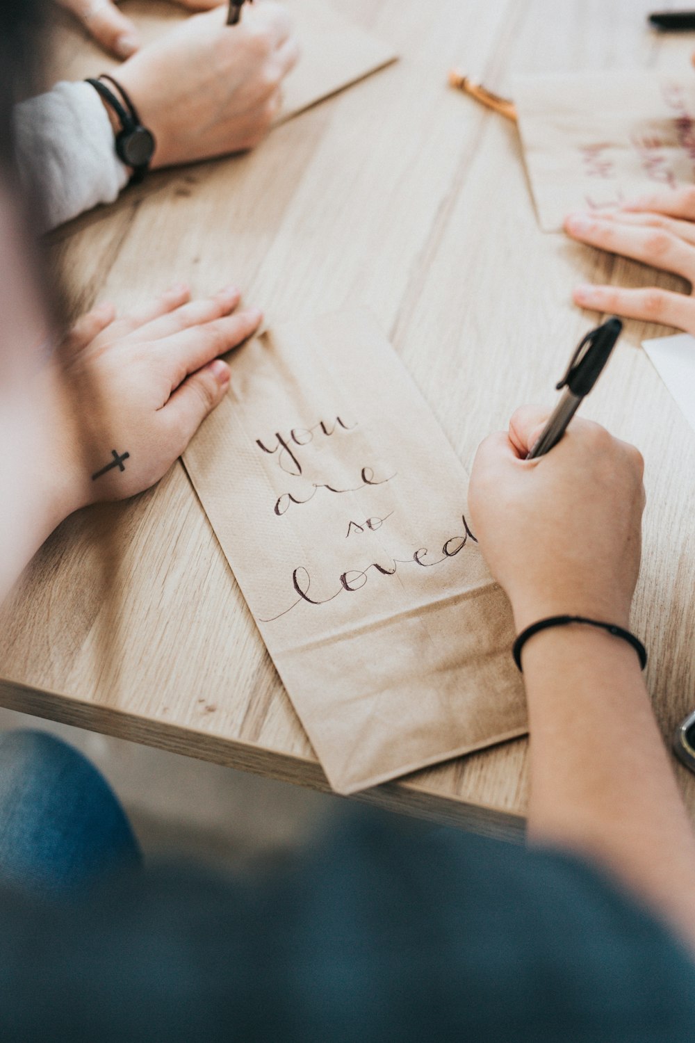 person writing on brown paper