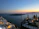 A happy couple enjoying a sunset dinner with a sea view at Priamos restaurant.