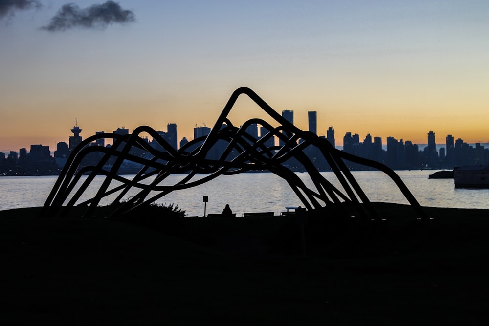 silhouette of buildings near body of water during golden hour