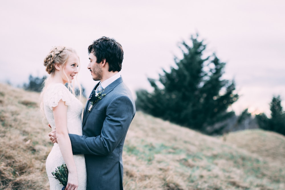 couple standing on hill during daytime