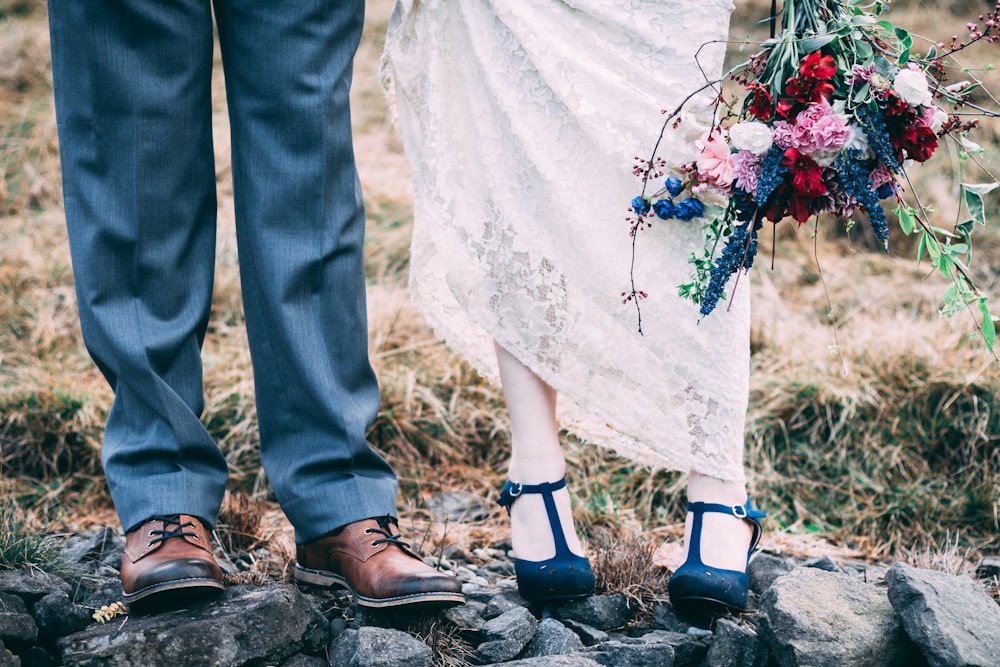 two person standing on rocks