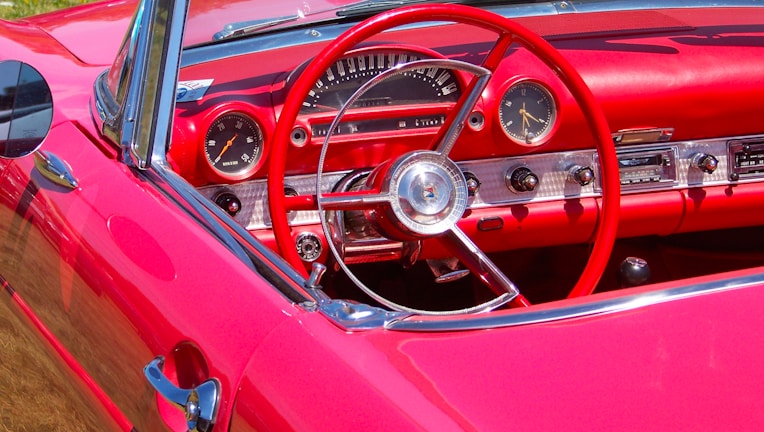 Interior shot showing a fully refurbished dashboard and seats of a restored car.
