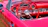 Cozy car interior featuring a sleek dashboard with a newly installed car radio glowing softly in deep crimson light.
