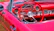 Cozy car interior featuring a sleek dashboard with a newly installed car radio glowing softly in deep crimson light.