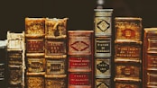 seven hardbound books on black surface