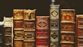 seven hardbound books on black surface