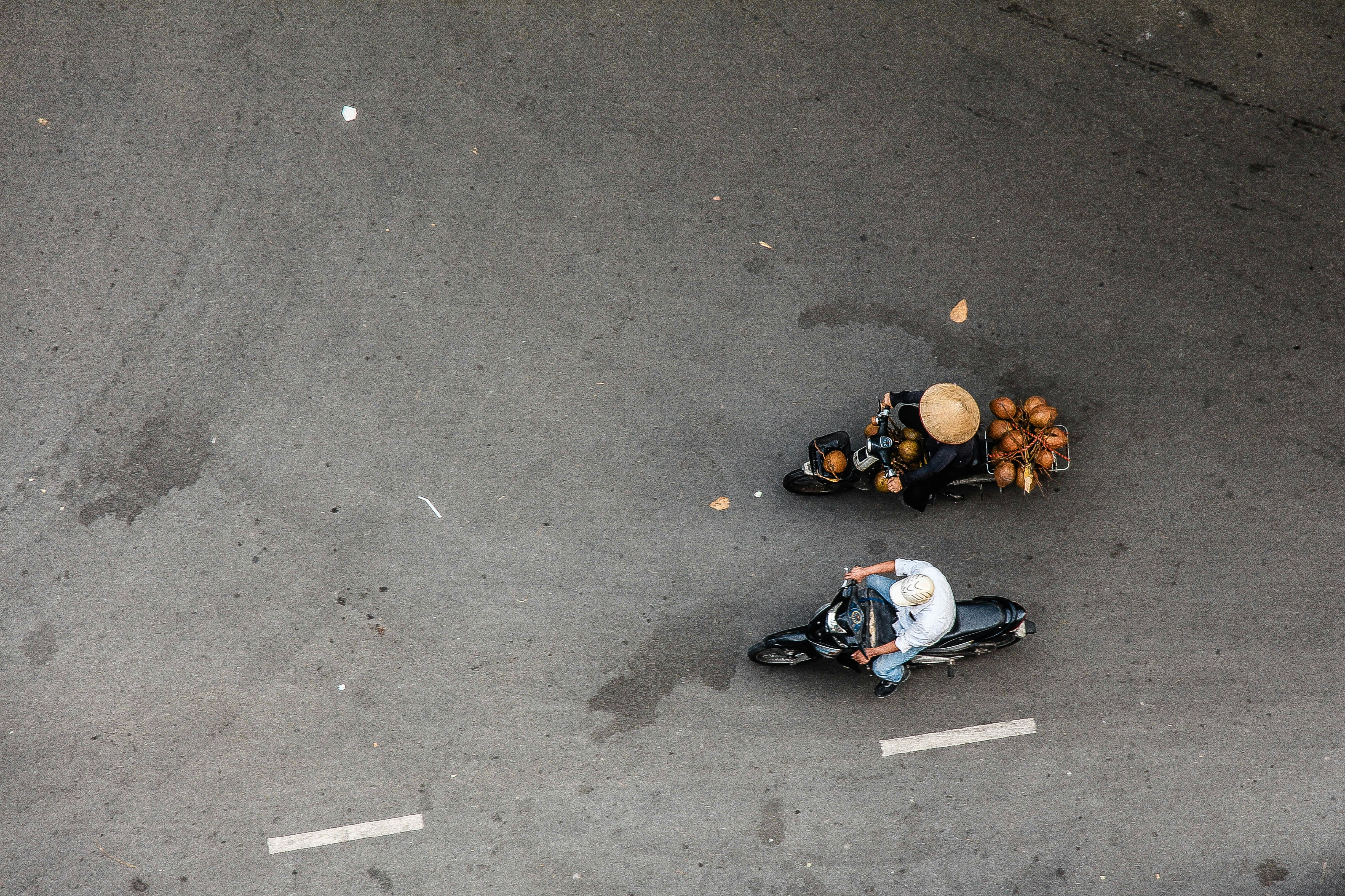 two people riding motorcycle on concrete road