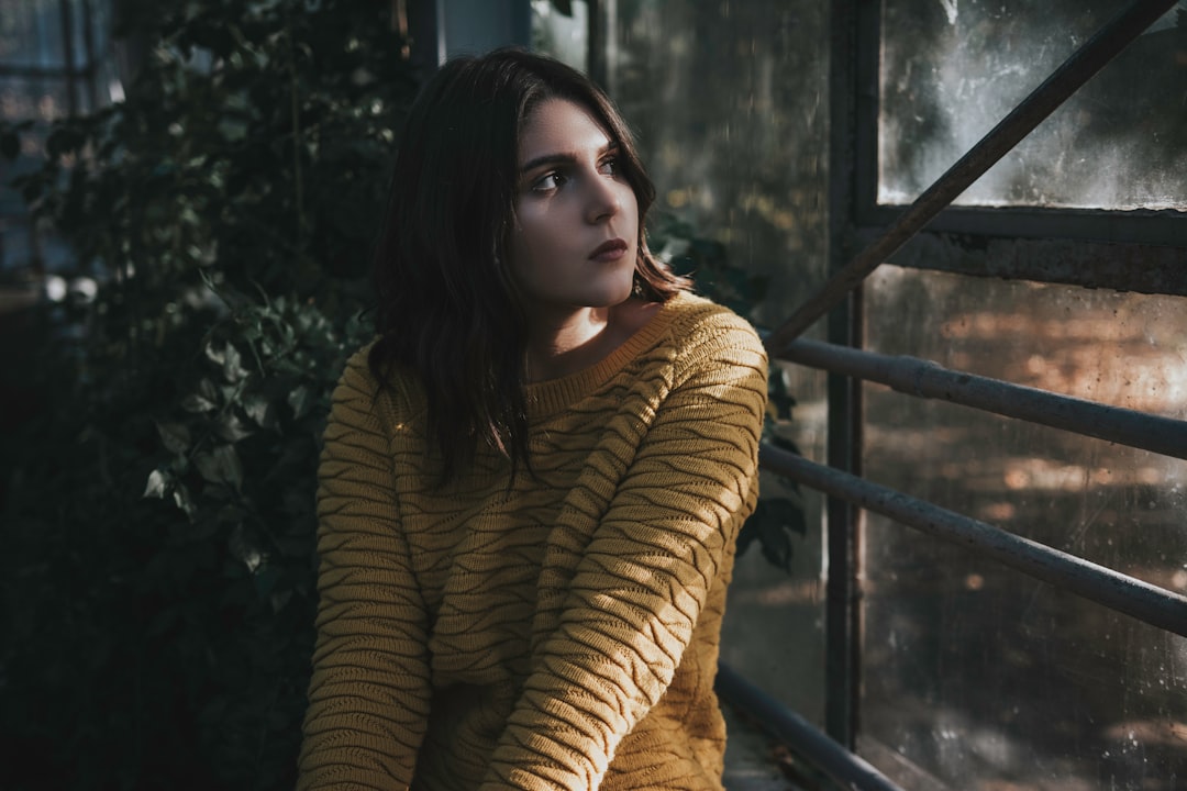 woman sitting in front of window