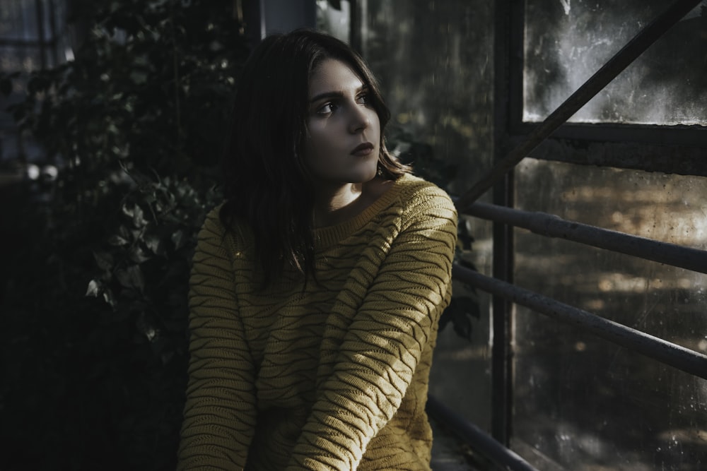 woman sitting in front of window