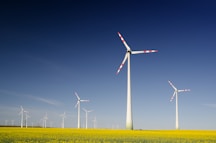 windmills on grass field at daytime