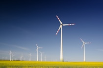 windmills on grass field at daytime