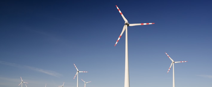 windmills on grass field at daytime