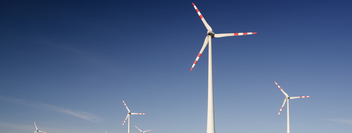 windmills on grass field at daytime