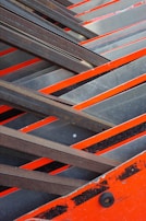 Close-up of rugged steel beams marked with safety orange paint, symbolizing durability.
