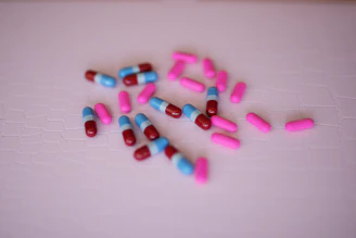 Close-up of the three color-coded pills—blue, pink, and obsidian—arranged neatly on a sleek white surface.