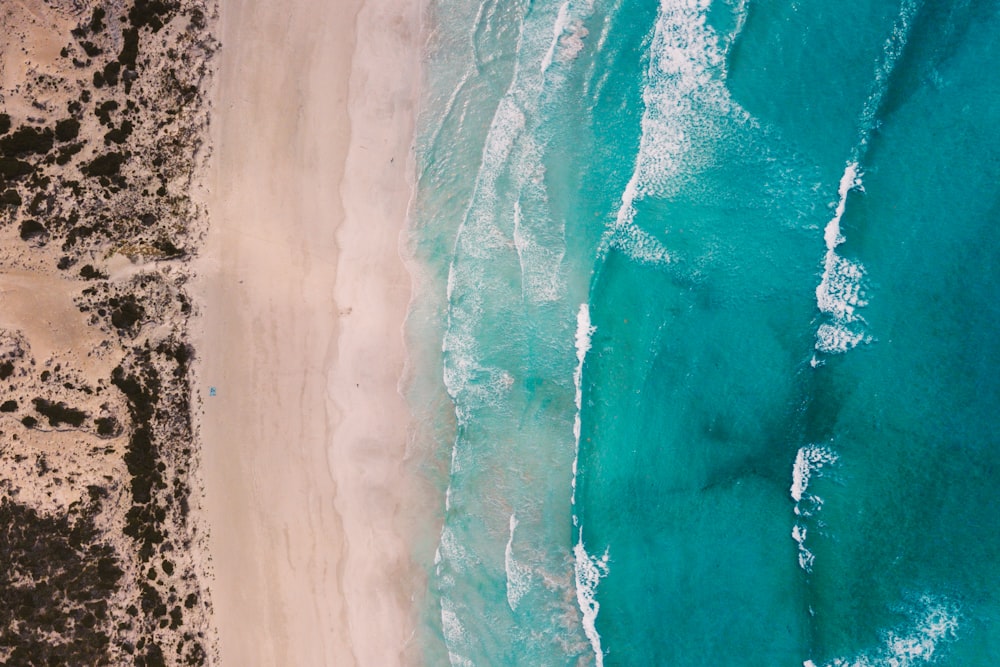 an aerial view of a sandy beach and ocean