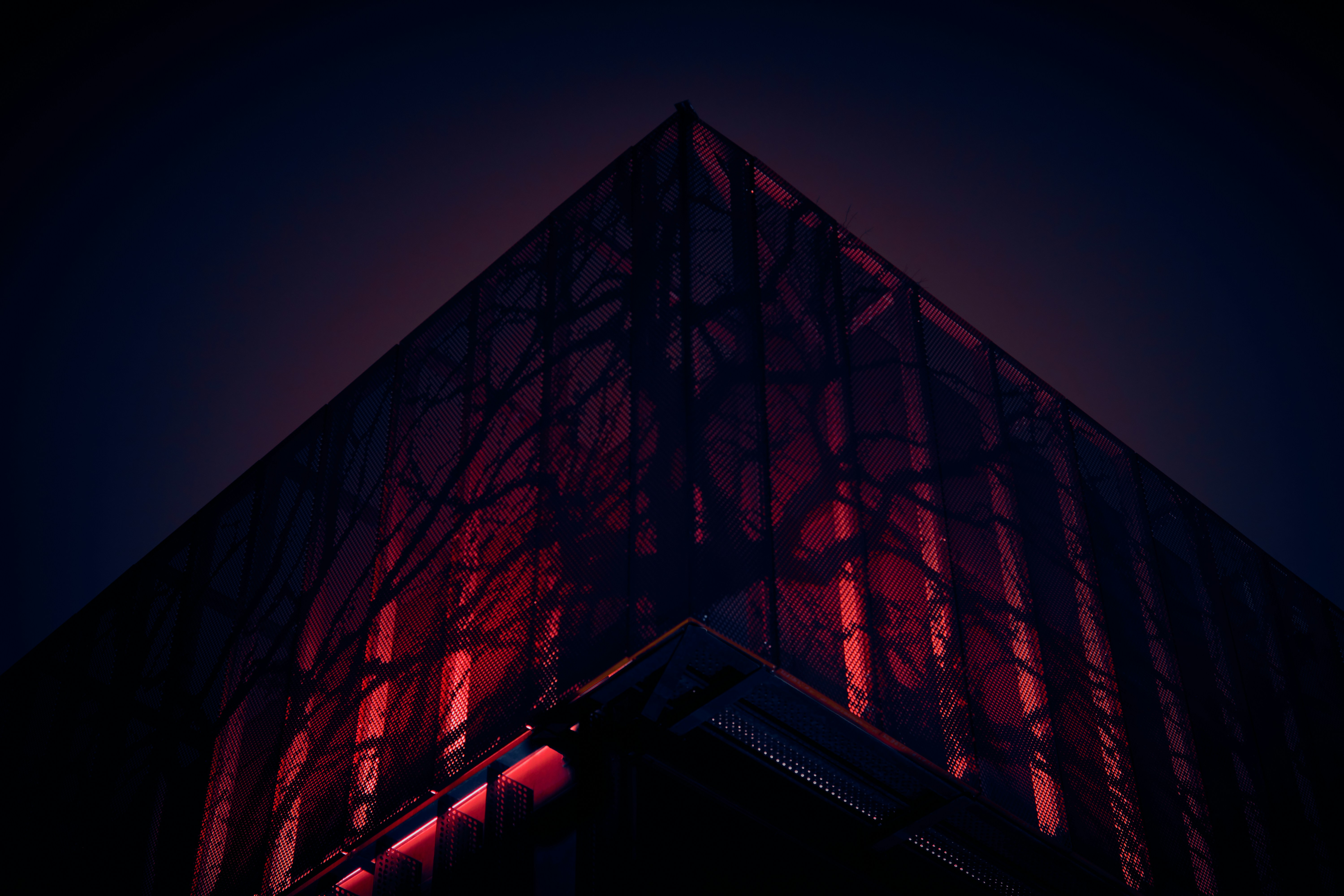 a tall building with a red light on it's side