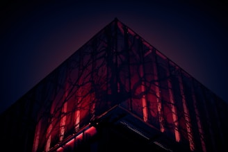 a tall building with a red light on it's side