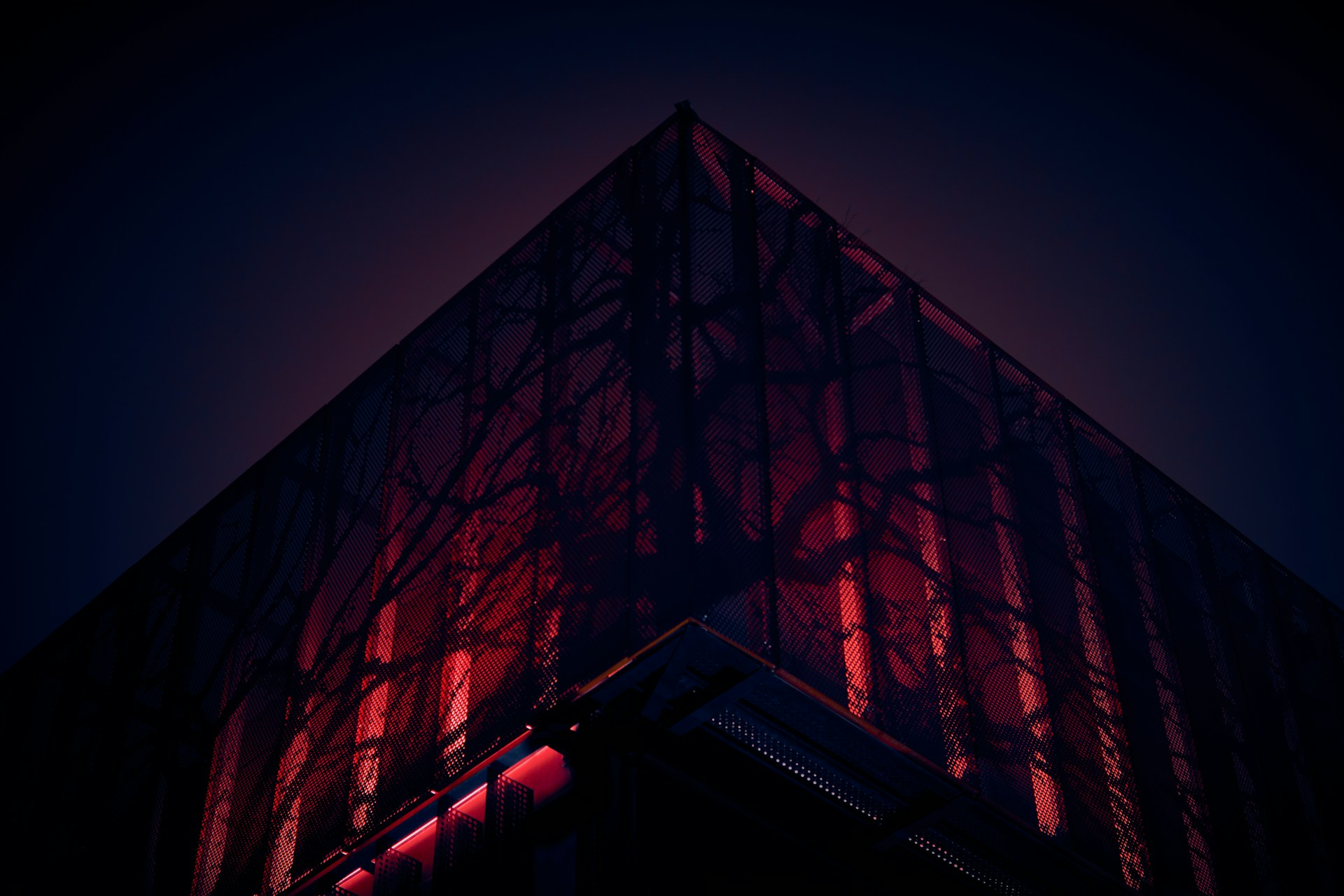 a tall building with a red light on it's side