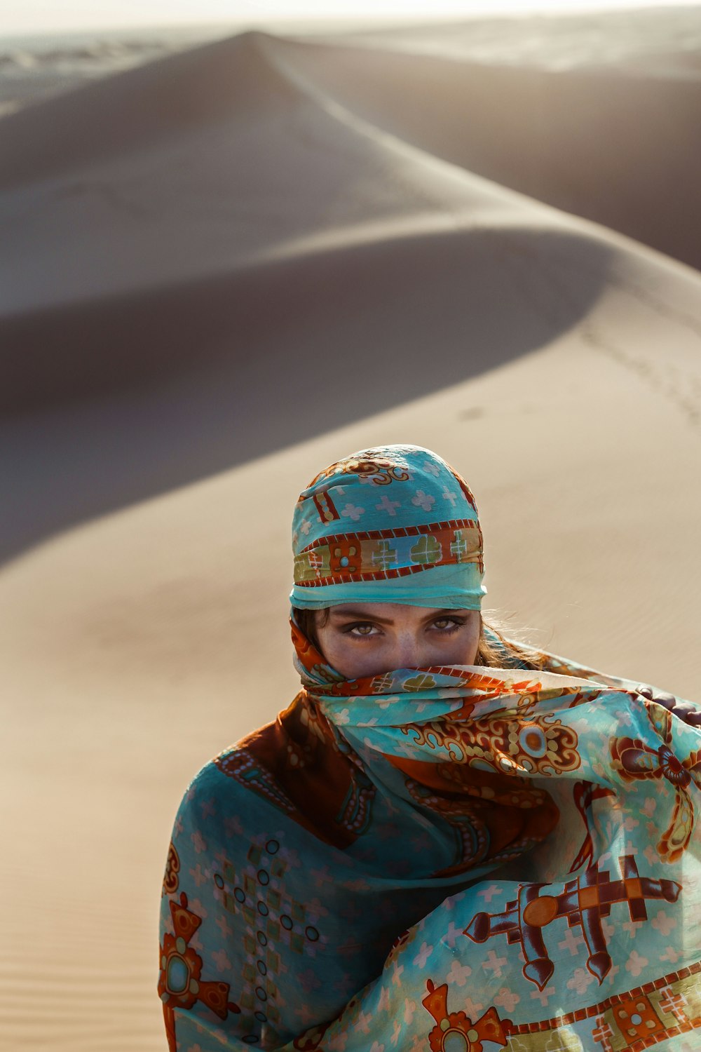 high-angle of woman walking on desert