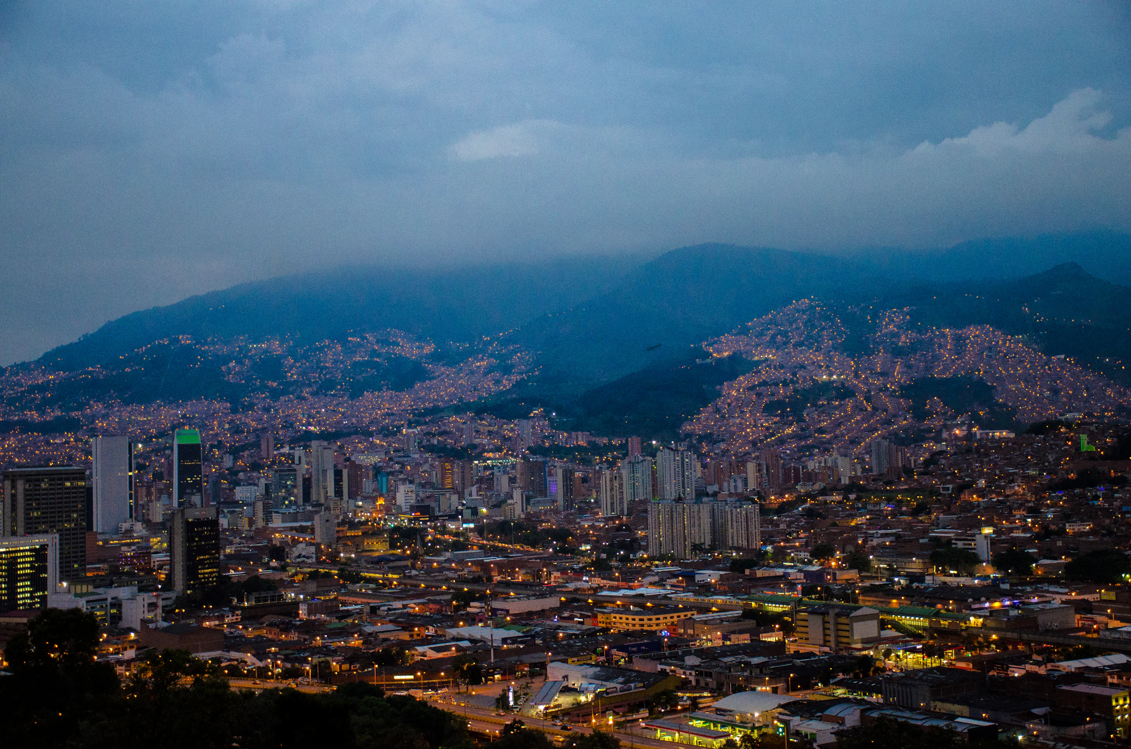 Medellín at night from the hillside, the valley lit from one ridge to the other