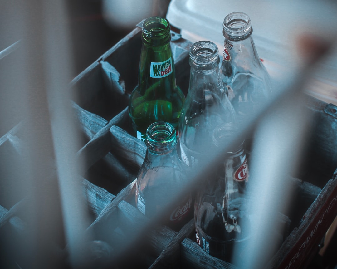 photo of glass soda bottles on crate