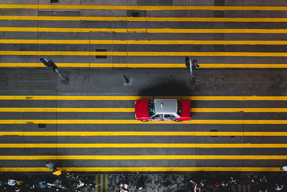 aerial photograph of gray and red car on street
