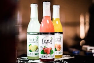 closeup photo of three sealed Habit labeled bottles