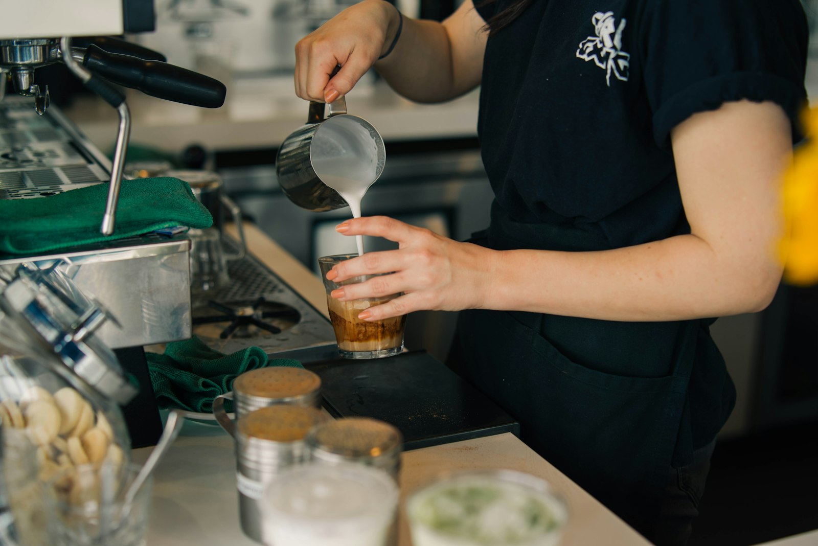 Sony a7R + E 50mm F1.4 sample photo. Person pouring milk in photography