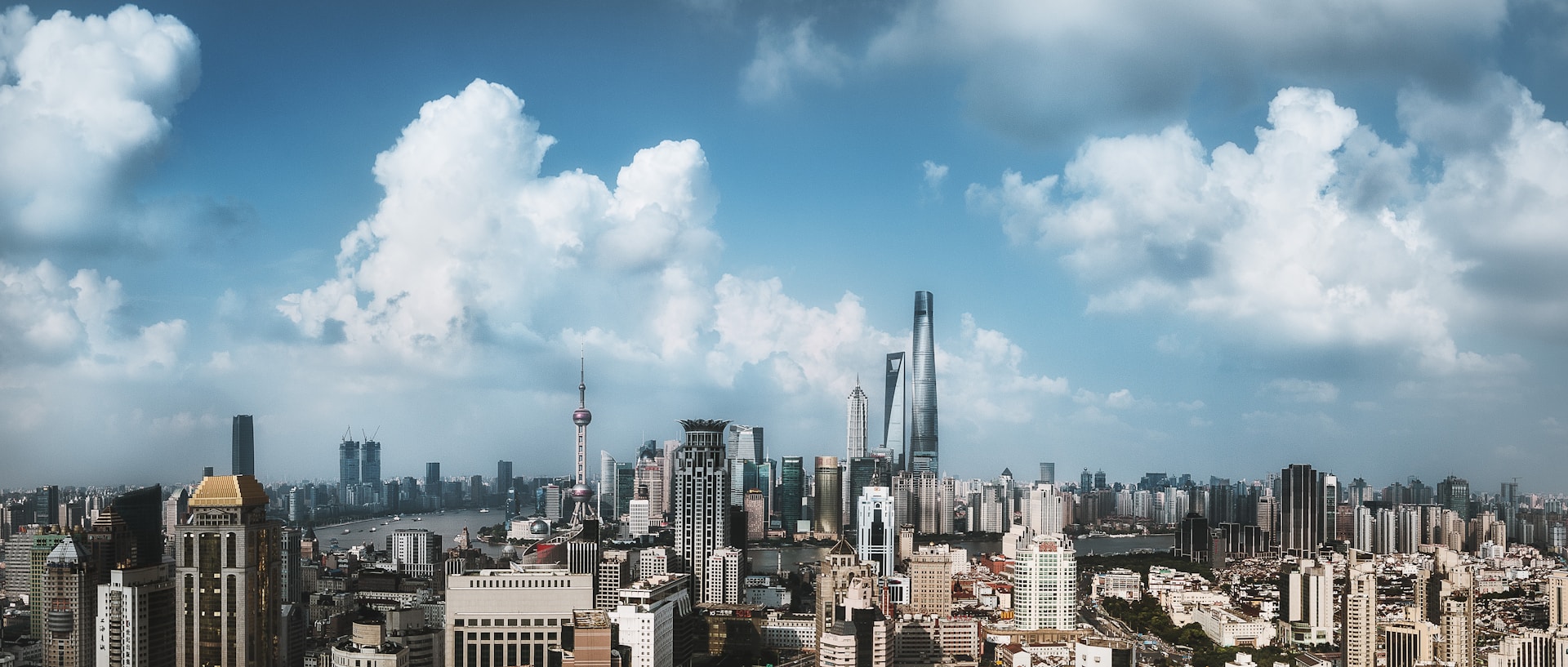 woman wearing yellow long-sleeved dress under white clouds and blue sky during daytime