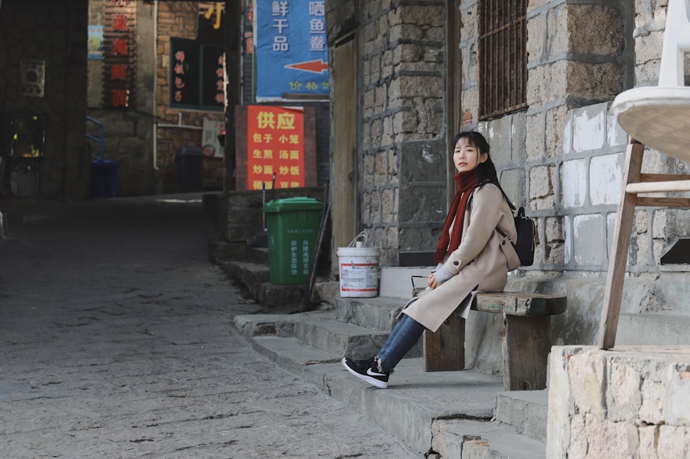 woman sitting on wood bench