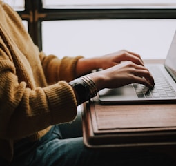 person sitting front of laptop in midst of digital operations work