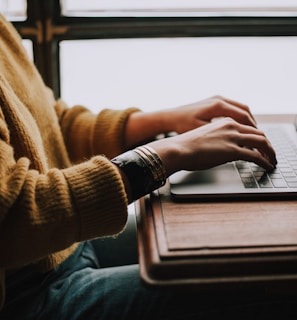 person sitting front of laptop