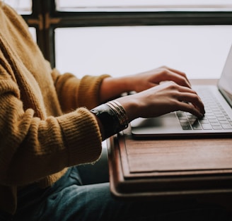 person sitting front of laptop