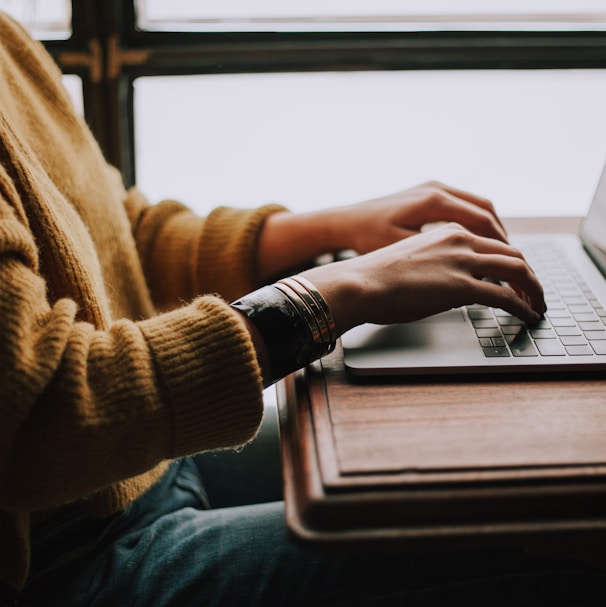 person sitting front of laptop