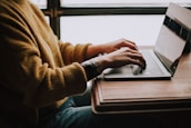 person sitting front of laptop